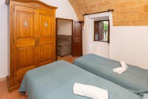 a bedroom with two twin beds and a closet at Villa moli de ca n'orell in Santanyi +37 photos