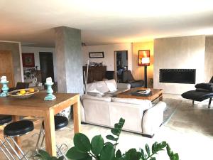 a living room with a white couch and a table at Ferme du Luberon in Mane