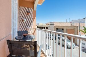 a balcony with a table and a tv at Casa García in L'Aldea
