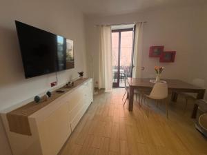 a living room with a flat screen tv on a wall at Casa Concordia in Agrigento
