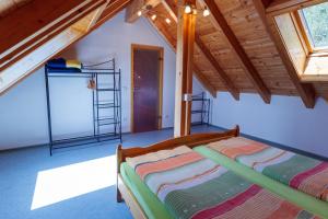 a bedroom with a bed in a attic at Hinterhauensteinhof in Hornberg
