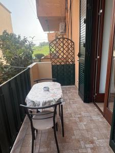 a table and two chairs on a balcony with a table and a window at Casa Concordia in Agrigento