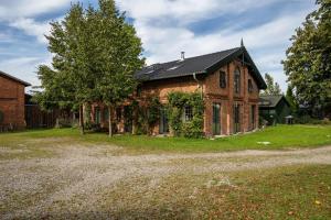 an old brick house with a black roof at Wohnung 1 Terrassenwohnung in Stockelsdorf