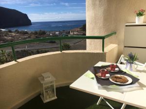 a table with a plate of food on a balcony at Apartment Los Cristianos in Los Cristianos
