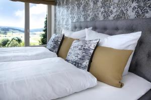 a bedroom with two beds with white sheets and pillows at Chillout in Ibach +19 photos
