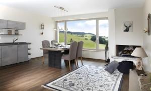a kitchen and dining room with a table and a fireplace at Chillout in Ibach