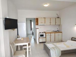 a living room with a table and a kitchen at Perasma Studios 11 in Kipri
