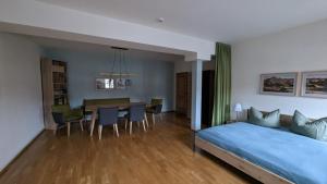 a bedroom with a bed and a dining room at Appartment am Markt in Weimar