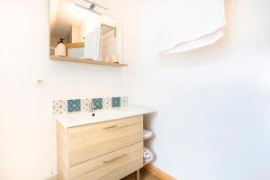 a bathroom with a sink and a mirror at Ce Petit Penty in Douarnenez +23 photos
