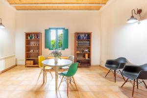 a dining room with a table and chairs at Mas Tortós in Palafolls