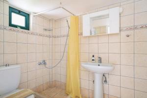 a bathroom with a toilet and a sink at Vardia studio A in Mikros Gialos +16 photos