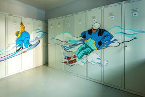 a room with lockers with drawings on them at BaikalSki Hostel in Baykalsk
