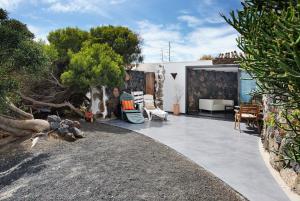 a patio with a couch and chairs in a yard at La Bodeguita House in Haría +15 photos