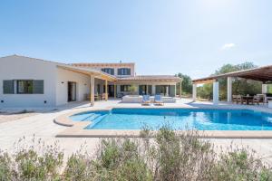 a villa with a swimming pool and a house at Villa Lorena in Islas Baleares