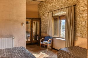 a bedroom with two beds and a window at Can Casadellà in Serra de Daró +66 photos