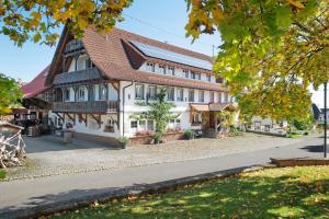 a large white building with a brown roof at Pension Ferienwohnung Baarblick in Donaueschingen