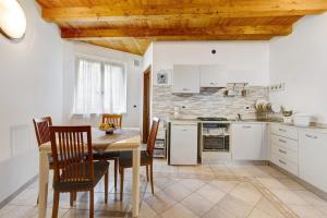 a kitchen with a table and chairs in a room at Maison Noris in Finale Ligure