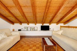 a living room with two couches and a tv at Maison Noris in Finale Ligure