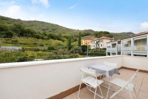 a balcony with a table and chairs on it at Maison Noris in Finale Ligure