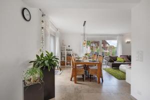 a dining room and living room with a table and chairs at Ferienwohnung Schneider in Blaubeuren