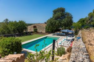 a swimming pool in the backyard of a house at Can Gallot De Punxuat - Pool in Algaida