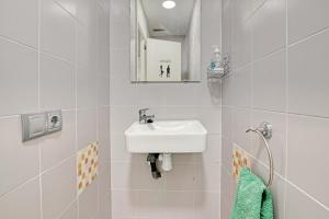 a white bathroom with a sink and a mirror at Albalat Tarongers in Albalat de Taronchers +16 photos