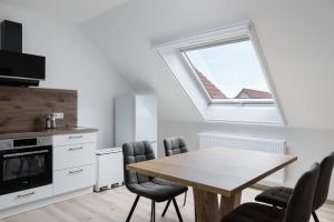 a kitchen with a table and chairs and a window at Ferienwohnung Rhön-Kutscher in Buttlar +22 photos