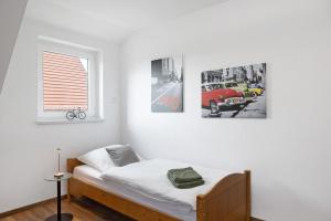 a bedroom with a bed with three pictures on the wall at Ferienwohnung Rhön-Kutscher in Buttlar