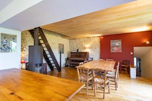 a dining room with a table and a fireplace at Gite des Bois du Charme in Chalais