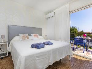 a bedroom with a bed with two towels on it at Villa Mi Capricho by Interhome in Calafell