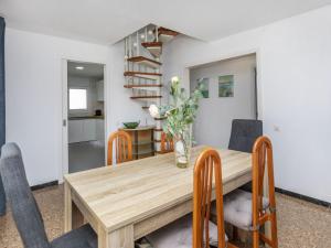 a dining room with a wooden table and chairs at Villa Mi Capricho by Interhome in Calafell