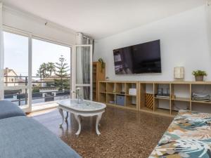 a living room with a couch and a tv at Villa Mi Capricho by Interhome in Calafell +35 photos