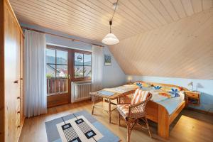 a bedroom with a bed and a desk and a table at Ferienwohnungen Müller in Haslach im Kinzigtal
