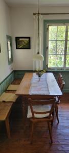 a dining room with a wooden table and chairs at Historisches Bahnwärterhaus in Gremmelsbach