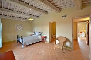 a bedroom with a bed and a table and chairs at Appartamento Pino in Trequanda +31 photos