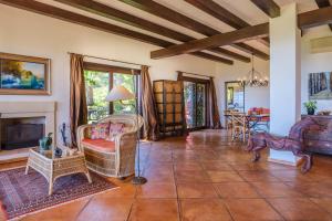 a living room filled with furniture and a fireplace at Sa Muntanya panorama in Santa Eularia des Riu