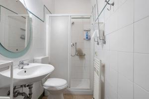a bathroom with a sink and a toilet and a shower at Coral House Viareggio in Viareggio +20 photos