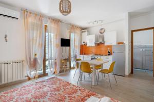 a kitchen and dining room with a table and chairs at Coral House Viareggio in Viareggio