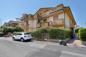 a white car parked in front of a building at Coral House Viareggio in Viareggio