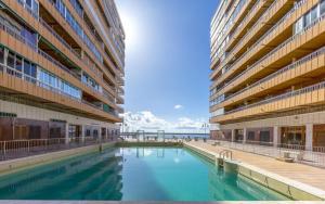 a swimming pool in the middle of a building at Sueña Mar Luxury Suites in Torrevieja