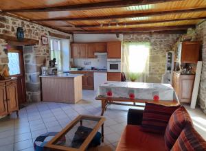 a kitchen with a pool table in the middle of a room at La Maisonnette in Goulles +9 photos