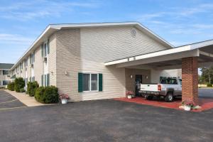 a white truck parked in front of a building at Iron Mountain Inn & Suites MI US 2 in Iron Mountain