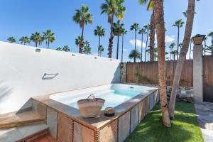 a swimming pool in a backyard with palm trees at Exclusive Villa with Heated Pool in Maspalomas