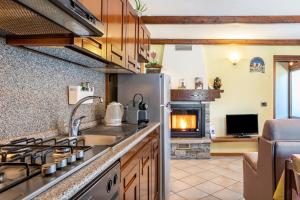 a kitchen with a refrigerator and a stove top oven at Lo Sondzo in Nus