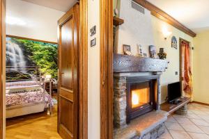 a living room with a stone fireplace at Lo Sondzo in Nus
