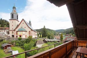 a view of a church from a balcony at Gästehaus Hanni in Todtmoos +18 photos