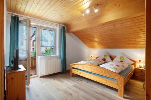a bedroom with a bed and a wooden ceiling at Gästehaus Hanni in Todtmoos
