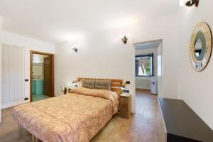 a bedroom with a bed and a mirror on the wall at Baia di Campo in Campomorone +17 photos