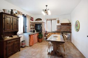 a kitchen with a wooden table in a room at Baia di Campo in Campomorone