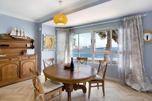 a dining room with a table and a large window at Ocean Side Arinaga in Arinaga